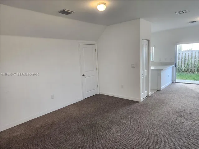 an empty room with a fireplace and a window