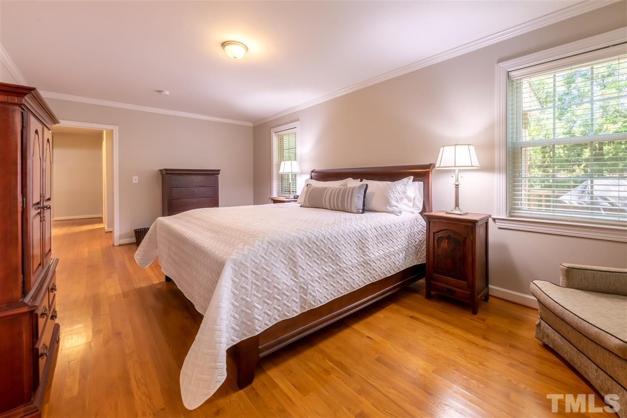 914 Canterbury Road Raleigh, NC 27607 - Photo 12 of 29 a bedroom with a bed and wooden floor