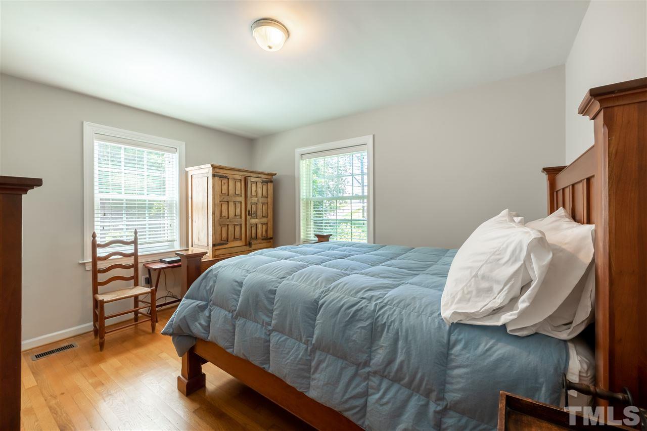914 Canterbury Road Raleigh, NC 27607 - Photo 13 of 29 a bedroom with a bed and a window