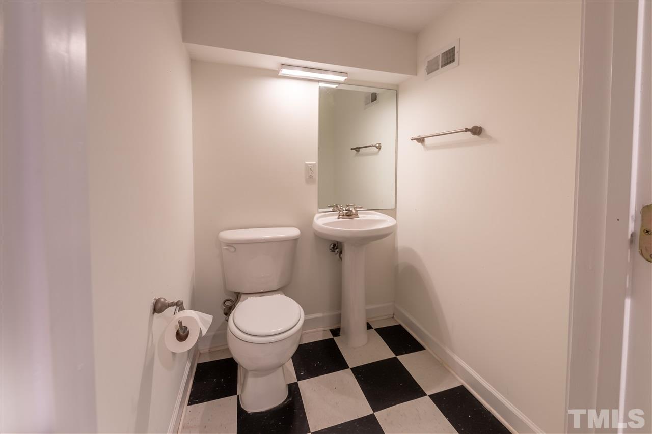 914 Canterbury Road Raleigh, NC 27607 - Photo 22 of 29 a white toilet sitting next to a bathroom sink