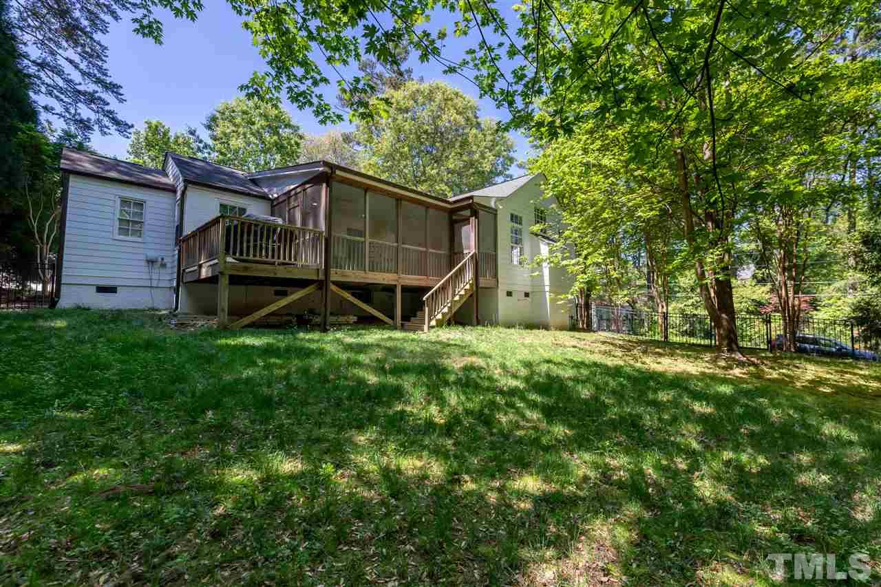 914 Canterbury Road Raleigh, NC 27607 - Photo 27 of 29 a backyard of a house with wooden fence and large trees