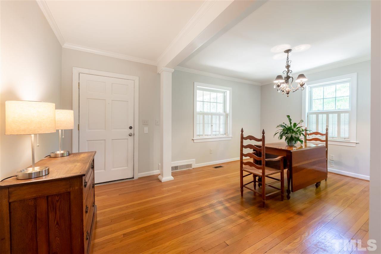 914 Canterbury Road Raleigh, NC 27607 - Photo 5 of 29 a living room with furniture and a chandelier