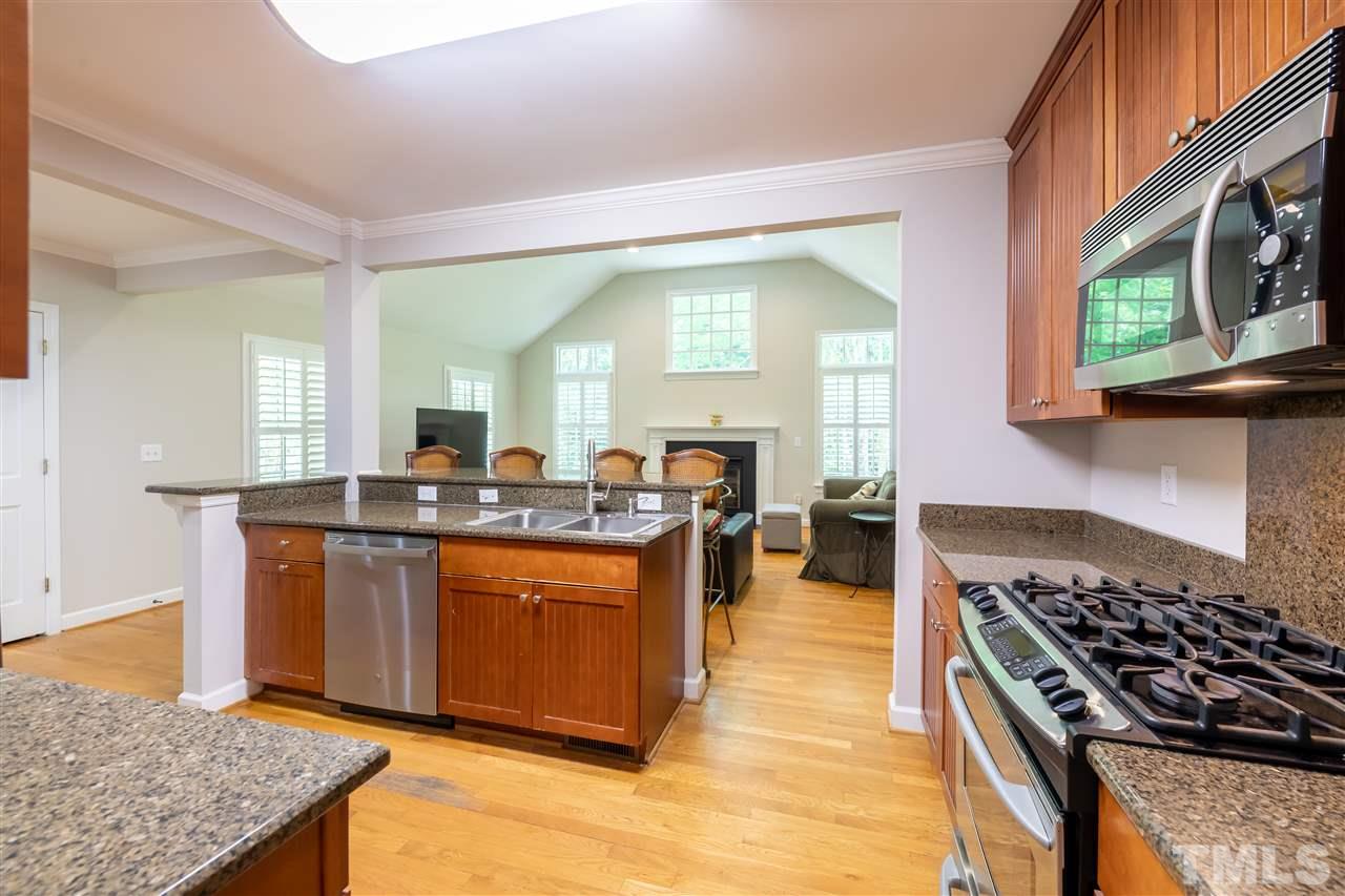 914 Canterbury Road Raleigh, NC 27607 - Photo 8 of 29 a kitchen with stainless steel appliances granite countertop a stove and a sink