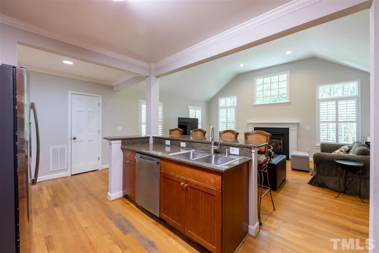914 Canterbury Road Raleigh, NC 27607 - Photo 9 of 29 a view of a kitchen counter top space with furniture wooden floor and windows