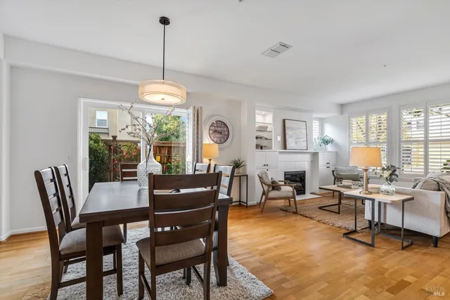 a dining room with furniture a chandelier and window
