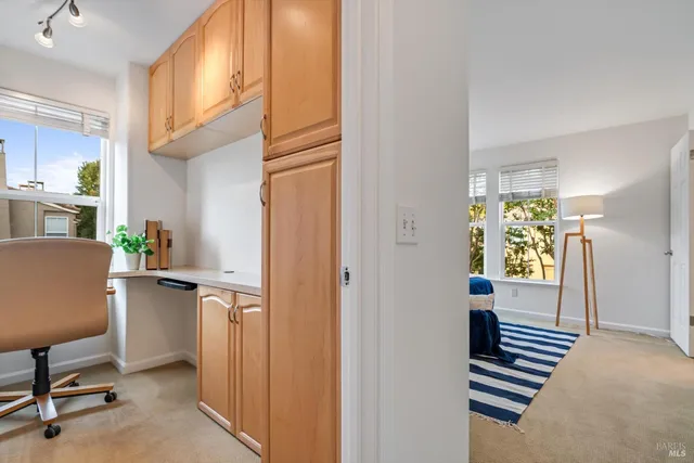 a view of kitchen with furniture and windows