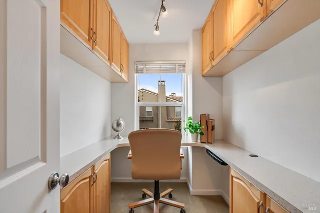 a view of a hallway with furniture and a window