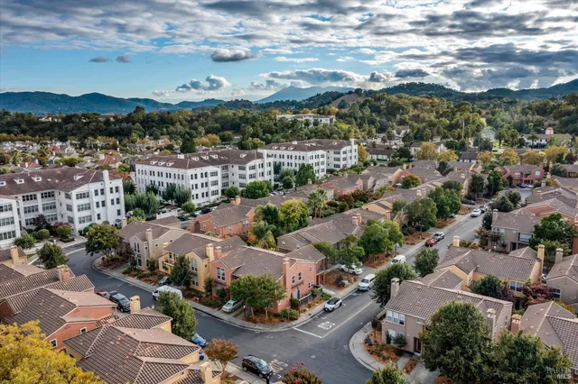 an aerial view of residential houses with outdoor space and street view