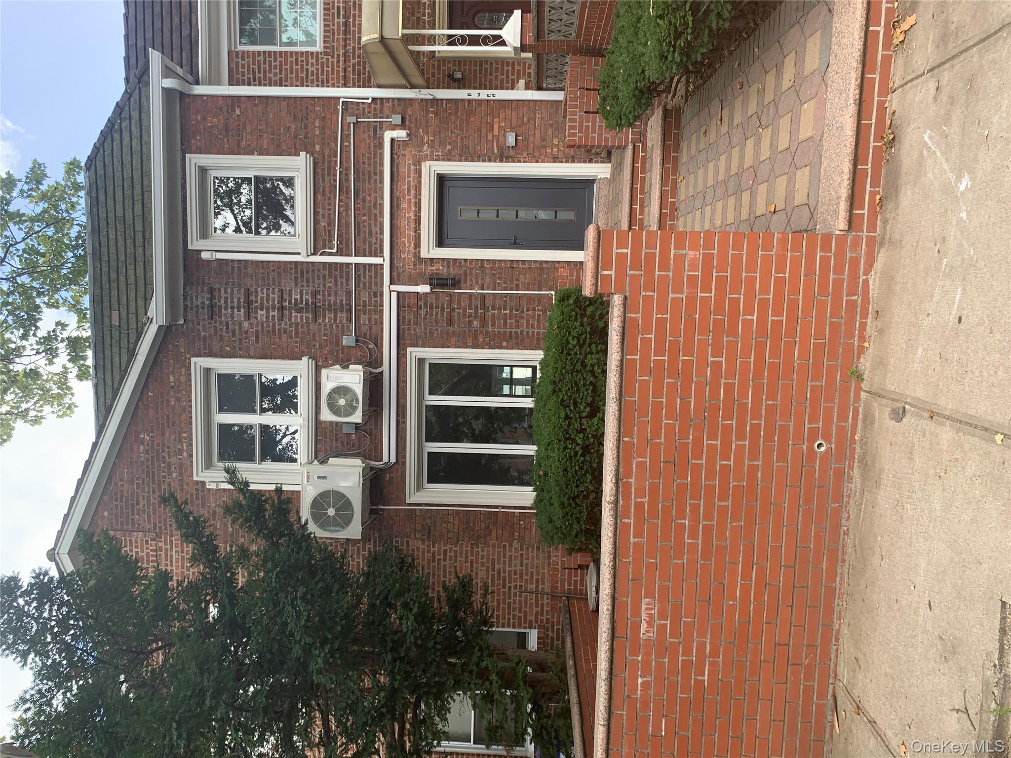 108-41 64th Road Queens, NY 11375 - Photo 1 of 1 View of front of home with brick siding