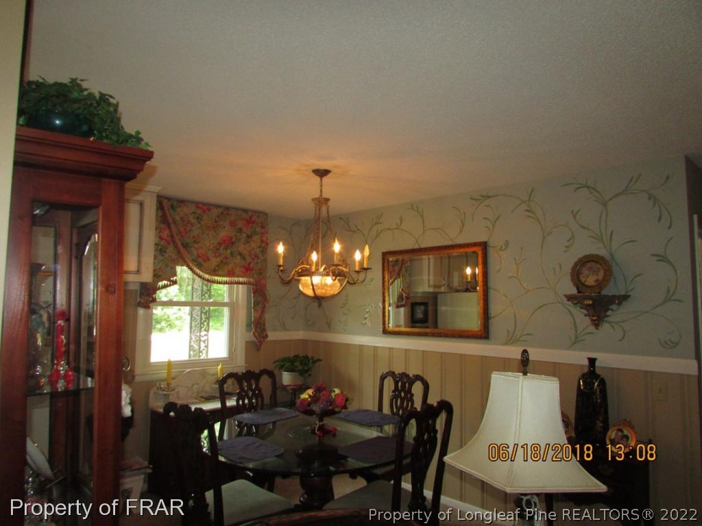 20 Page Road Godwin, NC 28344 - Photo 13 of 20 a view of a dining room with furniture and chandelier