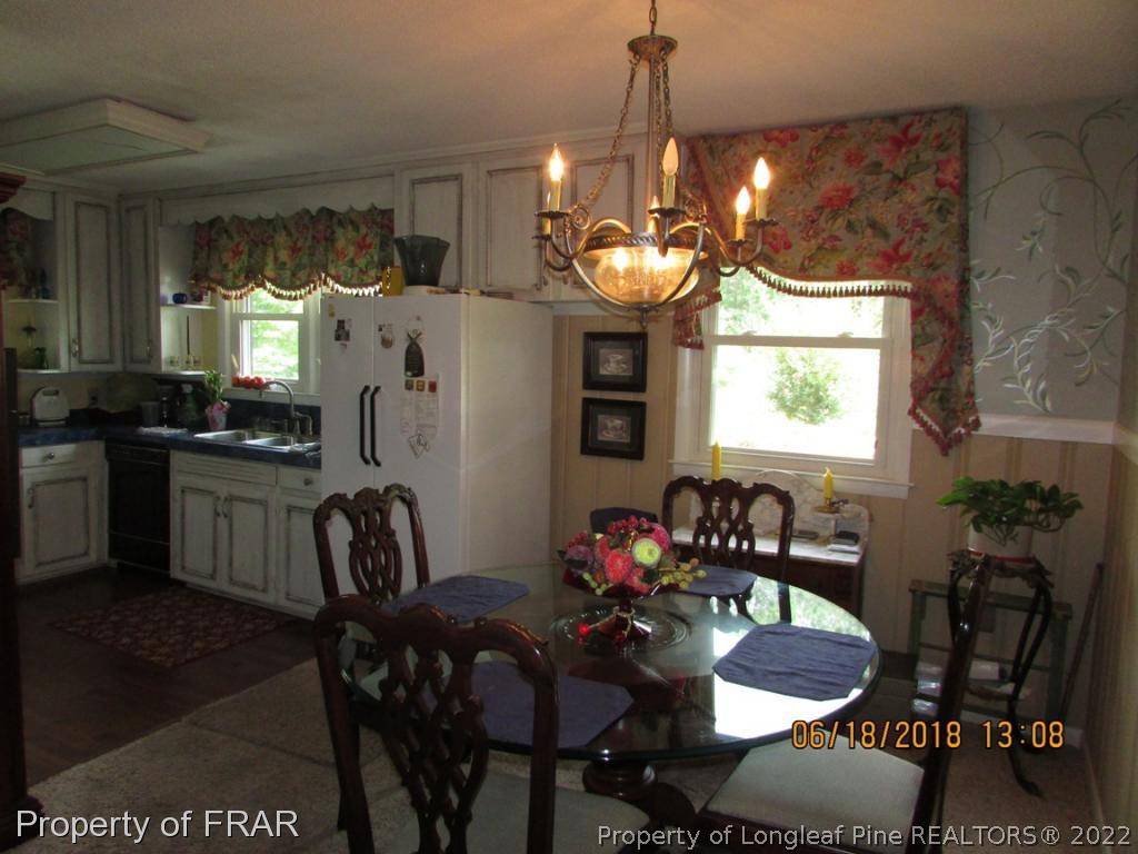 20 Page Road Godwin, NC 28344 - Photo 14 of 20 a view of a dining room with furniture and chandelier