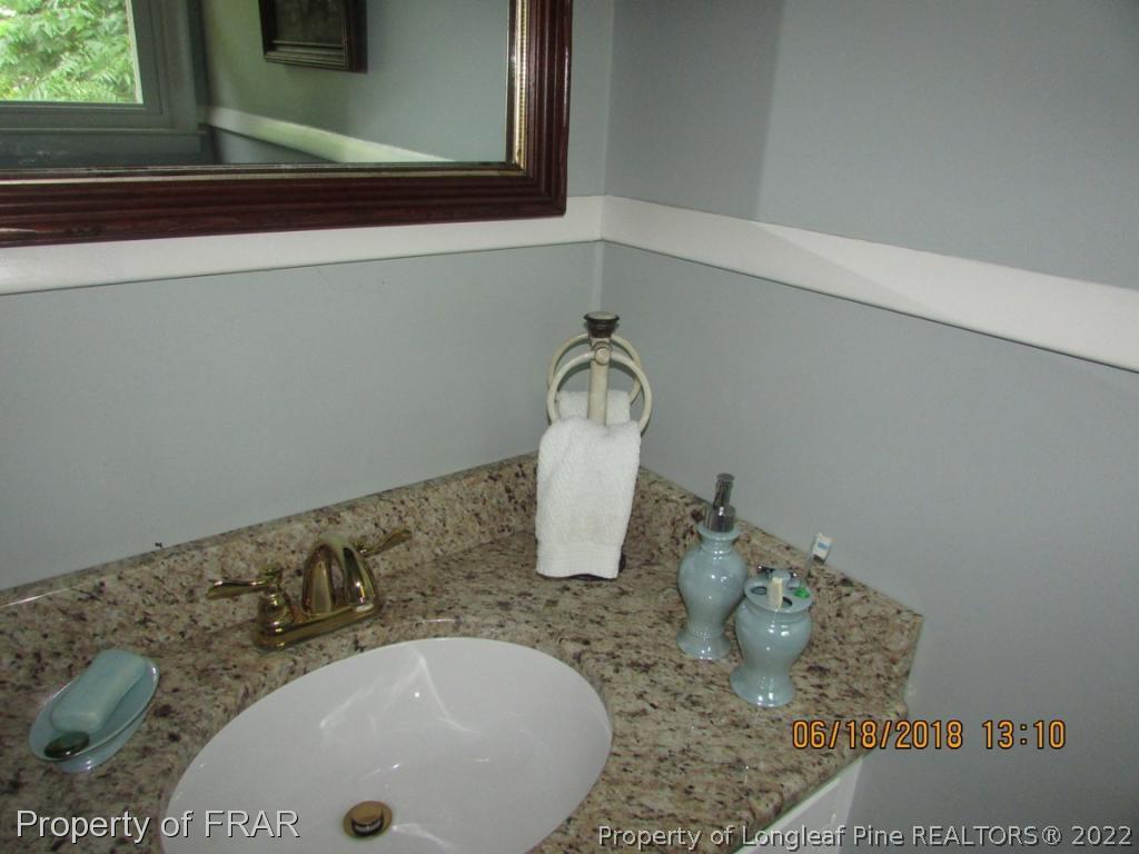 20 Page Road Godwin, NC 28344 - Photo 16 of 20 a bathroom with a sink and a mirror