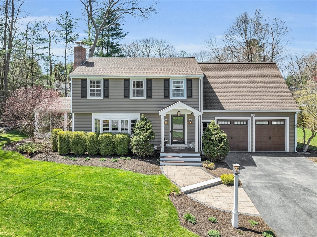 4 Thoreau Road Acton, MA 01720 - Photo 1 of 35 a front view of a house with a yard and potted plants