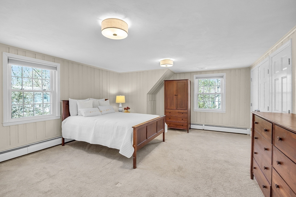 4 Thoreau Road Acton, MA 01720 - Photo 23 of 35 a spacious bedroom with a bed and a window