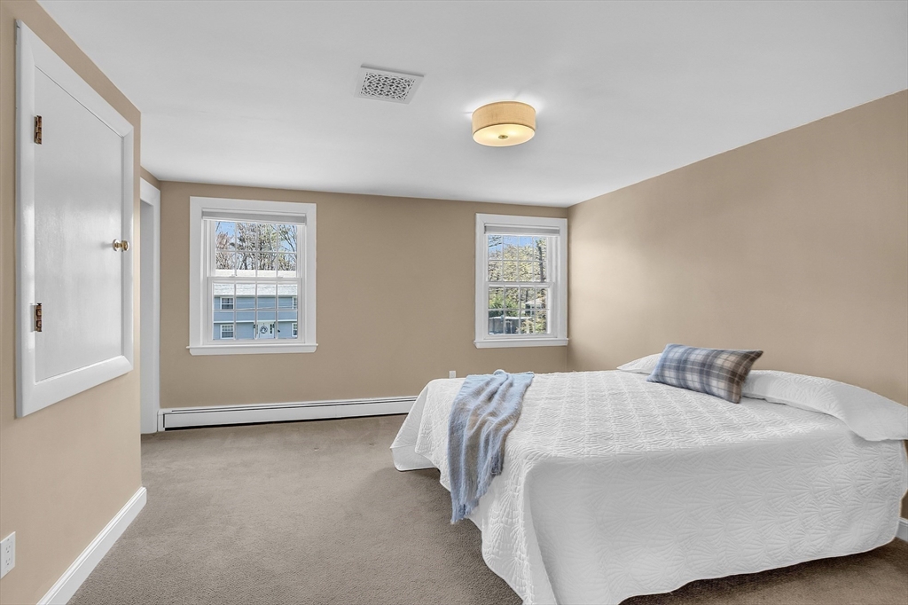 4 Thoreau Road Acton, MA 01720 - Photo 27 of 35 a bedroom with a bed and a window