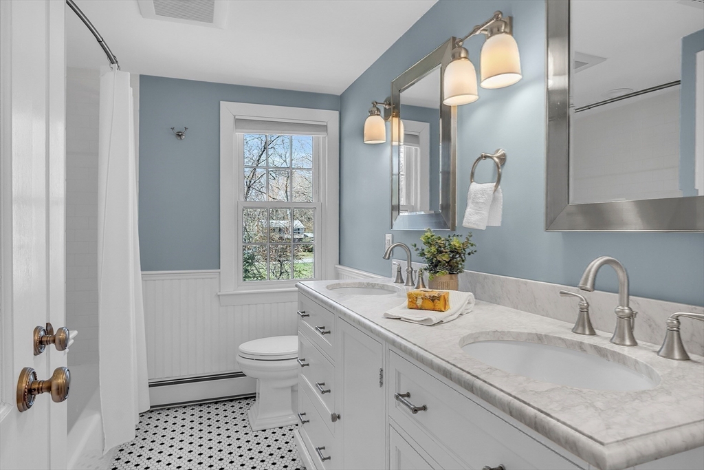 4 Thoreau Road Acton, MA 01720 - Photo 28 of 35 a bathroom with a sink a toilet and a large mirror