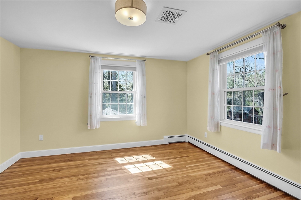 4 Thoreau Road Acton, MA 01720 - Photo 31 of 35 a view of an empty room with wooden floor and a window