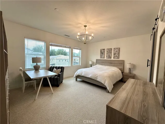 a bedroom with a bed and a table