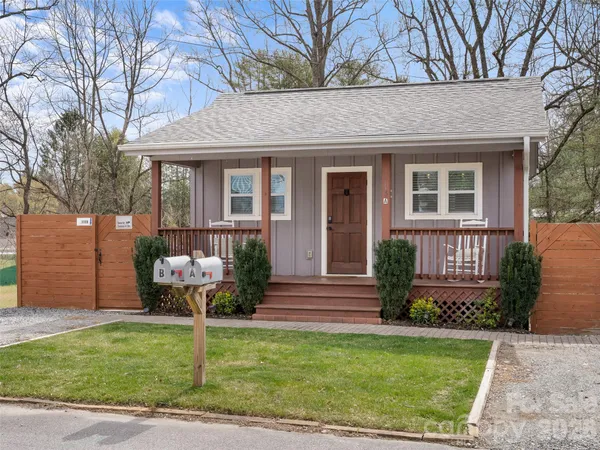a front view of house with a garden