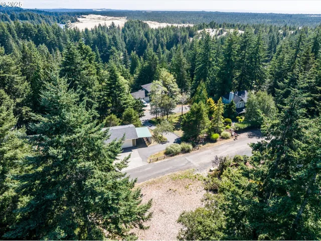 an aerial view of a house with yard