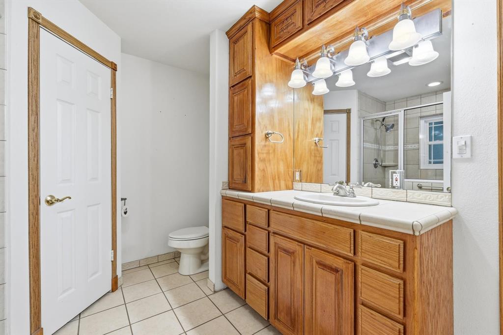 123 Valley Ranch Road Sherman, TX 75092 - Photo 16 of 40 Full bath with vanity, a shower stall, and light tile patterned flooring
