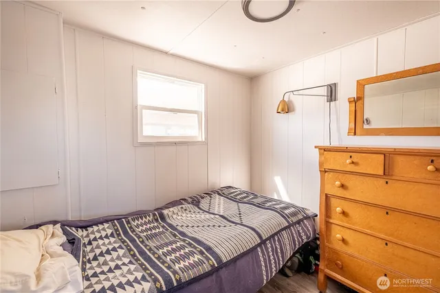 a bedroom with a bed and window