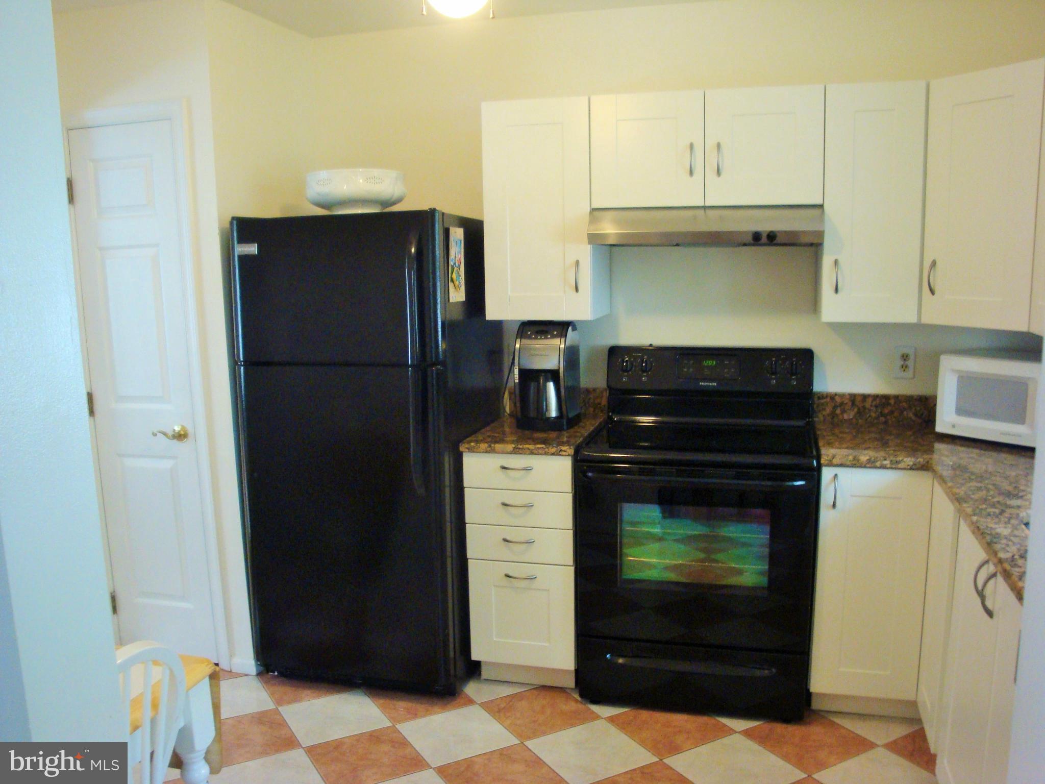 10159 Marshall Pond Road Burke, VA 22015 - Photo 11 of 28 a kitchen with a refrigerator and cabinets