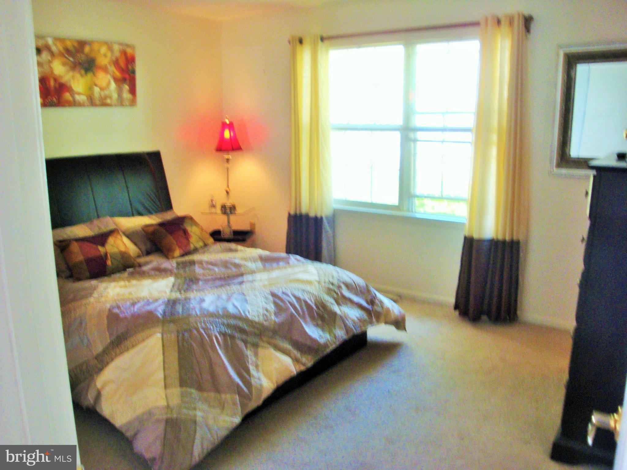 10159 Marshall Pond Road Burke, VA 22015 - Photo 12 of 28 a bedroom with a bed and a window
