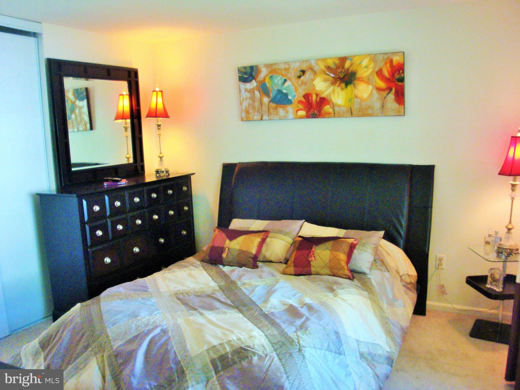 10159 Marshall Pond Road Burke, VA 22015 - Photo 13 of 28 a bedroom with a bed and painting on the wall