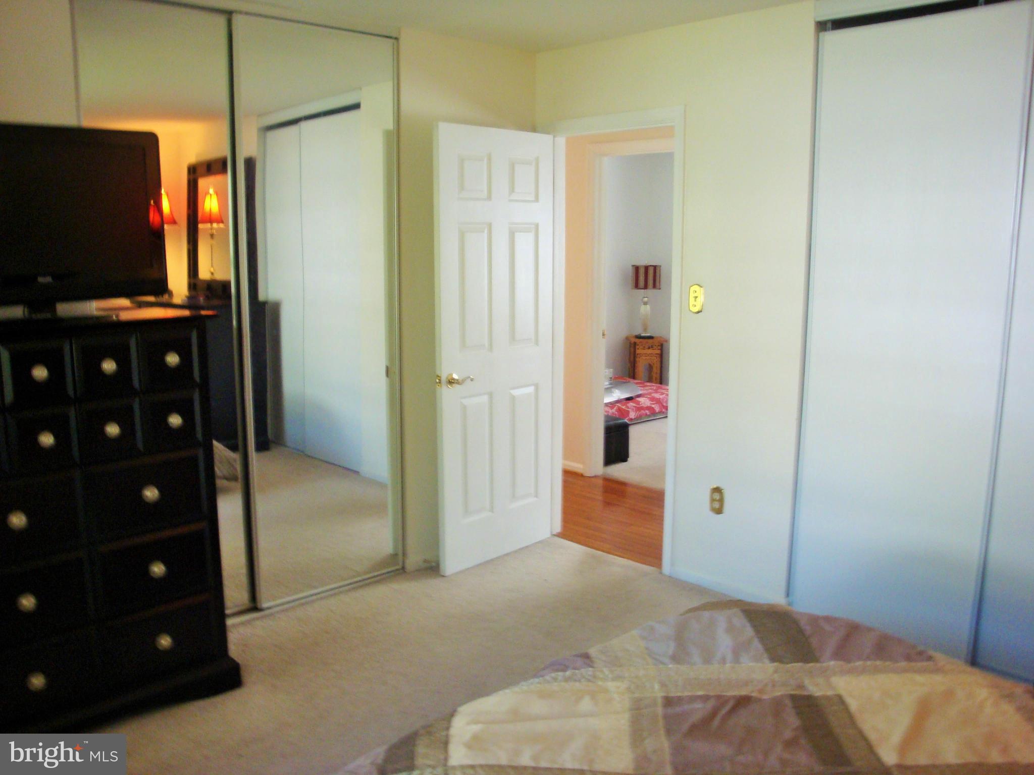 10159 Marshall Pond Road Burke, VA 22015 - Photo 14 of 28 a bedroom with a bed and a flat screen tv
