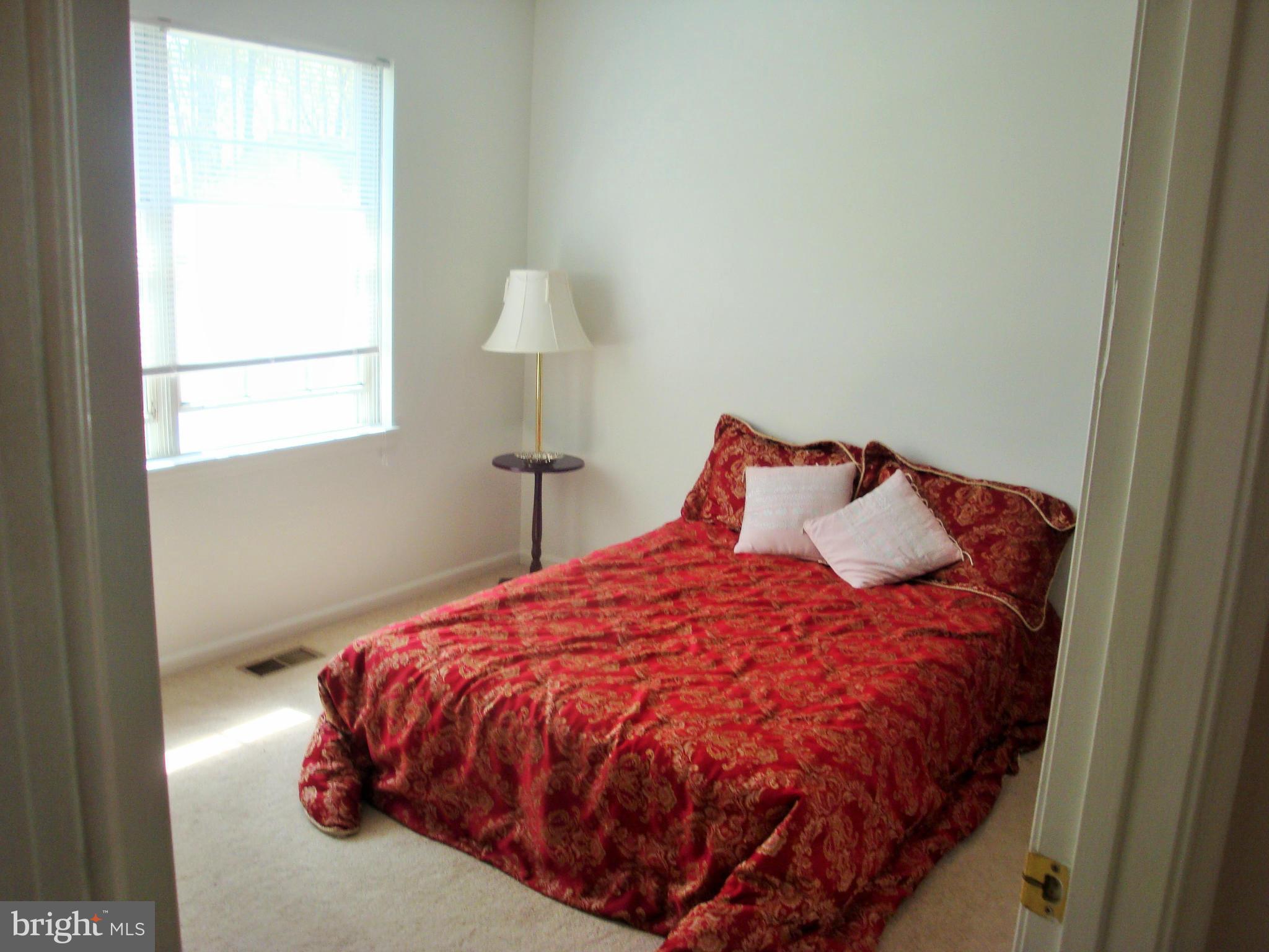 10159 Marshall Pond Road Burke, VA 22015 - Photo 16 of 28 a bed sitting in a bedroom next to a window