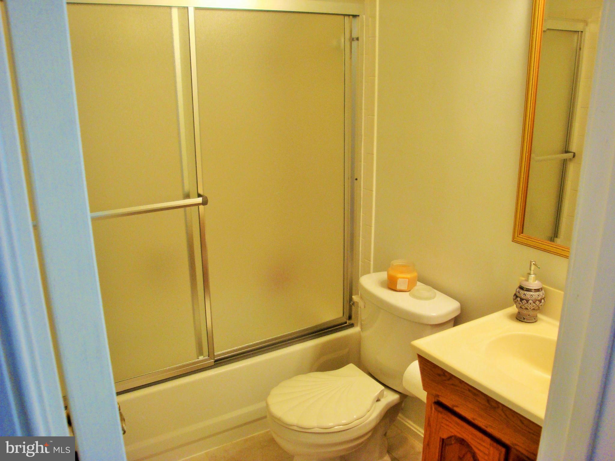 10159 Marshall Pond Road Burke, VA 22015 - Photo 18 of 28 a white toilet sitting next to a bathroom sink