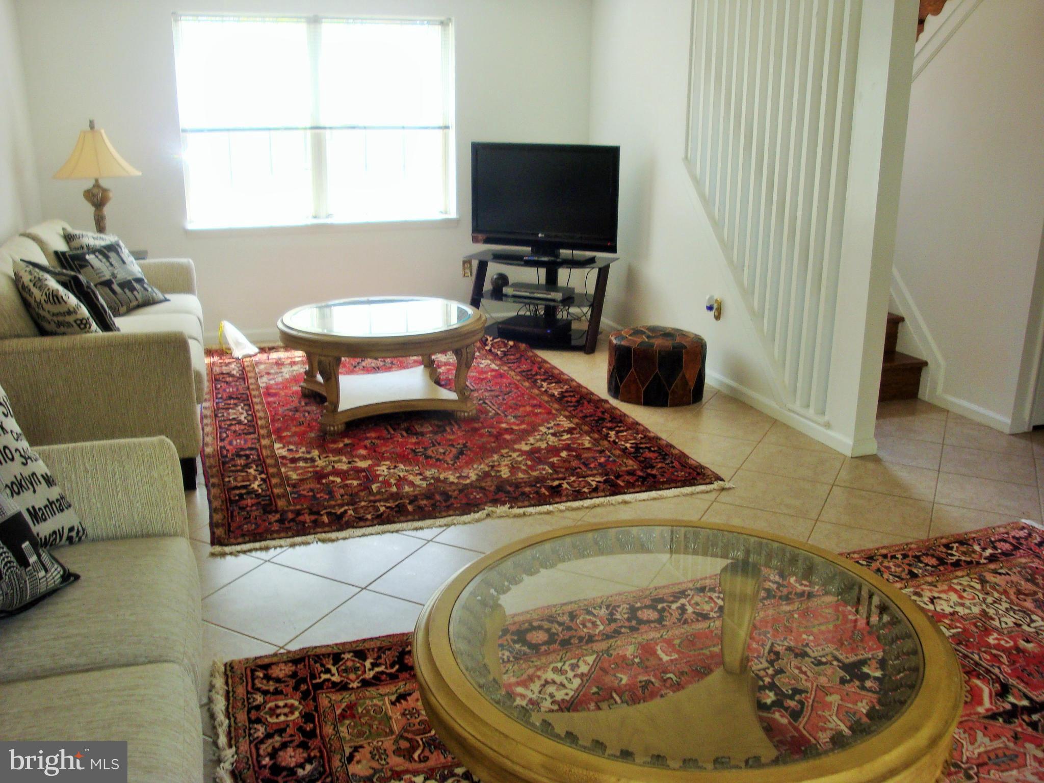 10159 Marshall Pond Road Burke, VA 22015 - Photo 20 of 28 a living room with a couch and a flat screen tv
