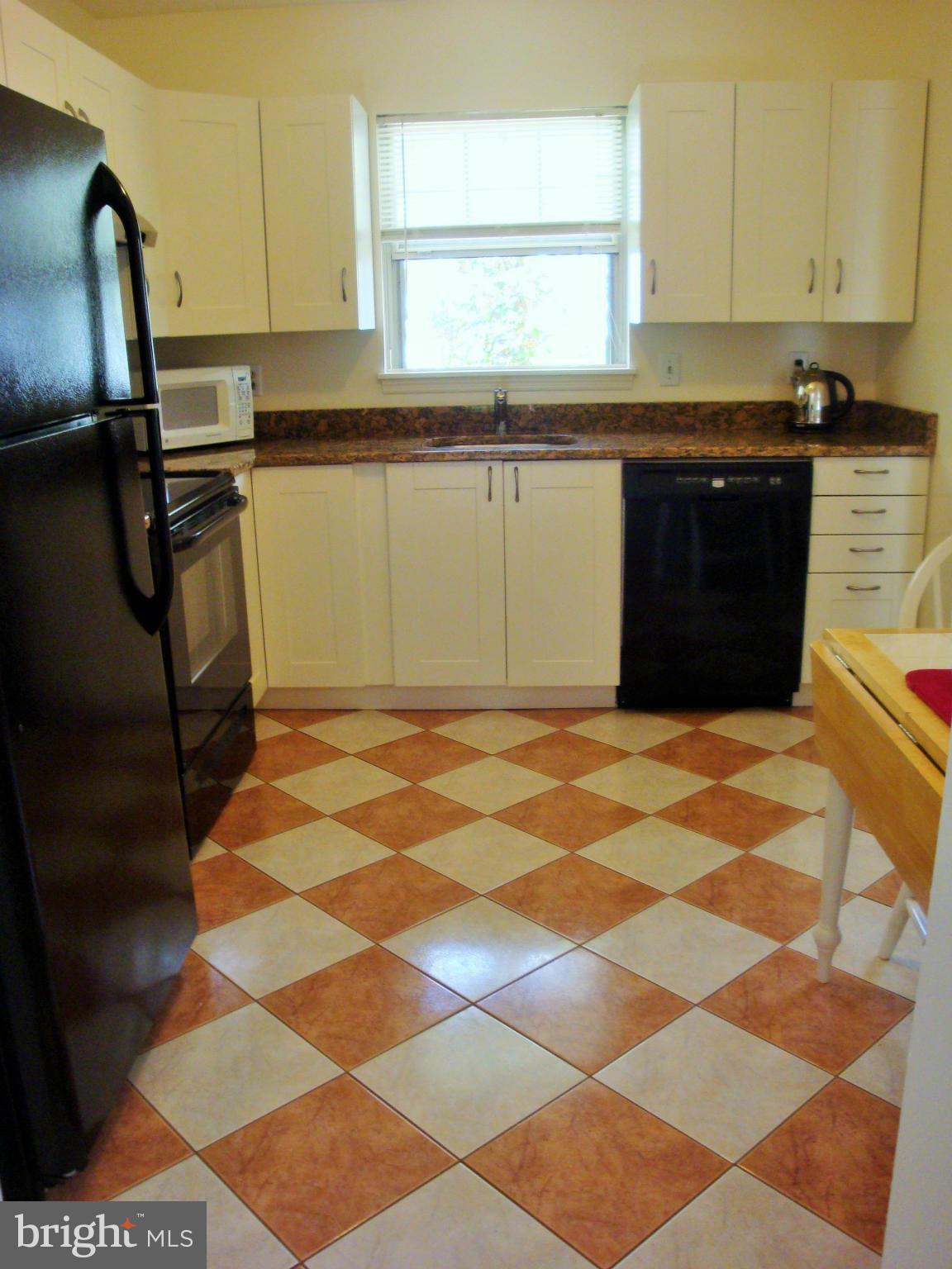 10159 Marshall Pond Road Burke, VA 22015 - Photo 10 of 28 a kitchen with a sink a stove and a window