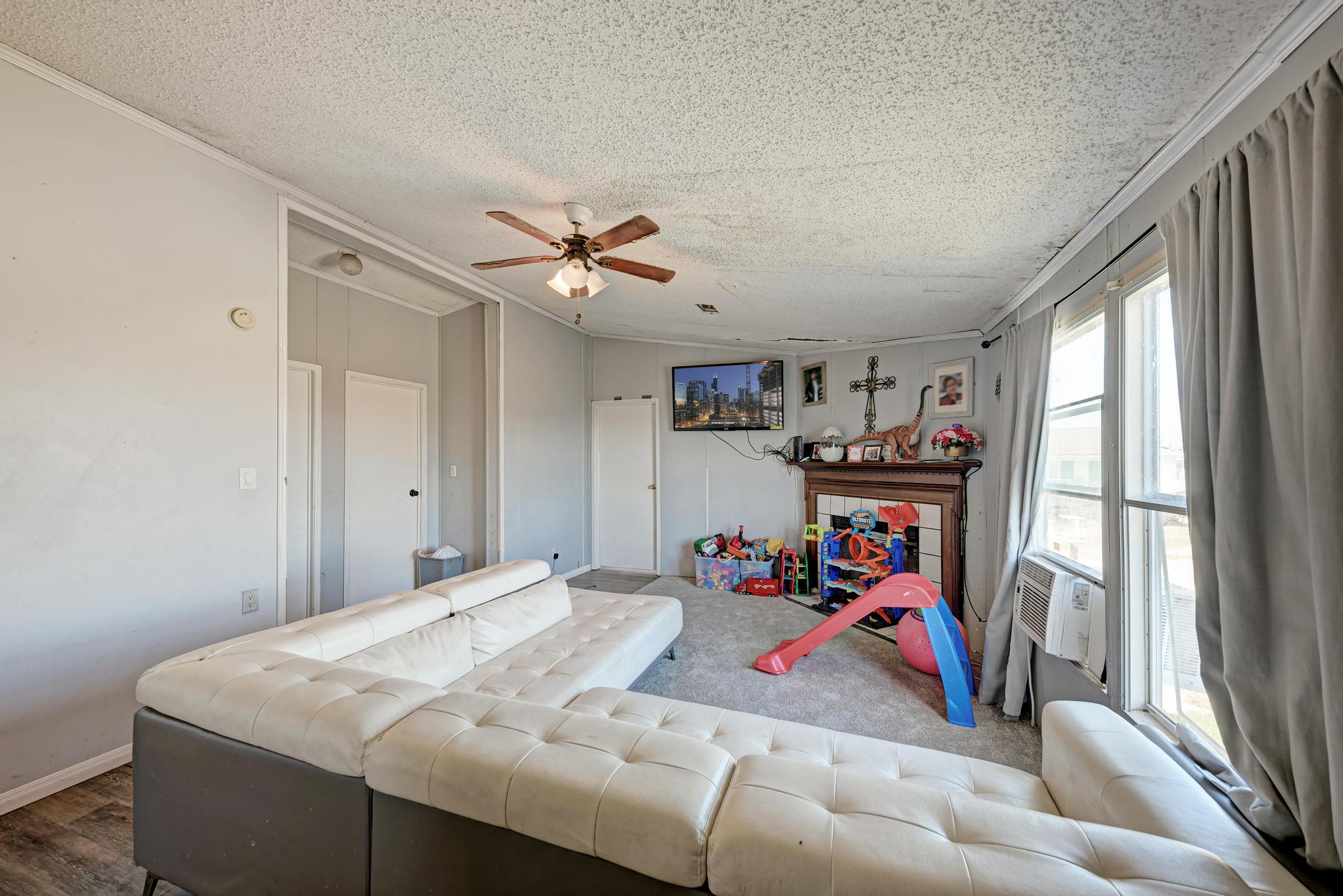 20113 Maynard Court Coupland, TX 78615 - Photo 13 of 37 a bed sitting in a bedroom next to a window