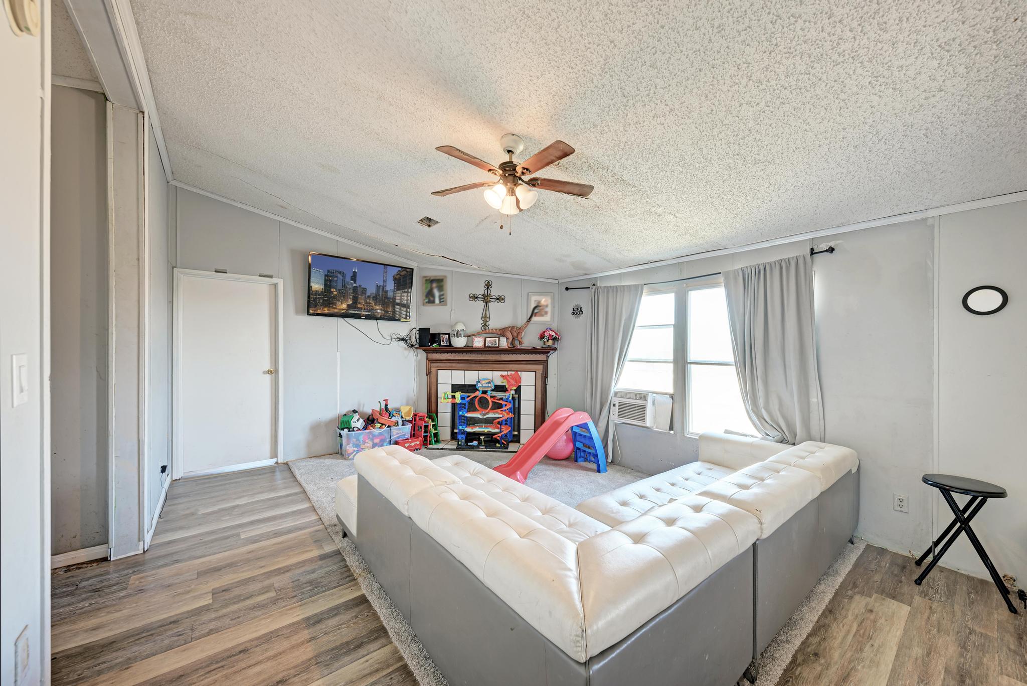 20113 Maynard Court Coupland, TX 78615 - Photo 14 of 37 a bed room with a bed and a chandelier