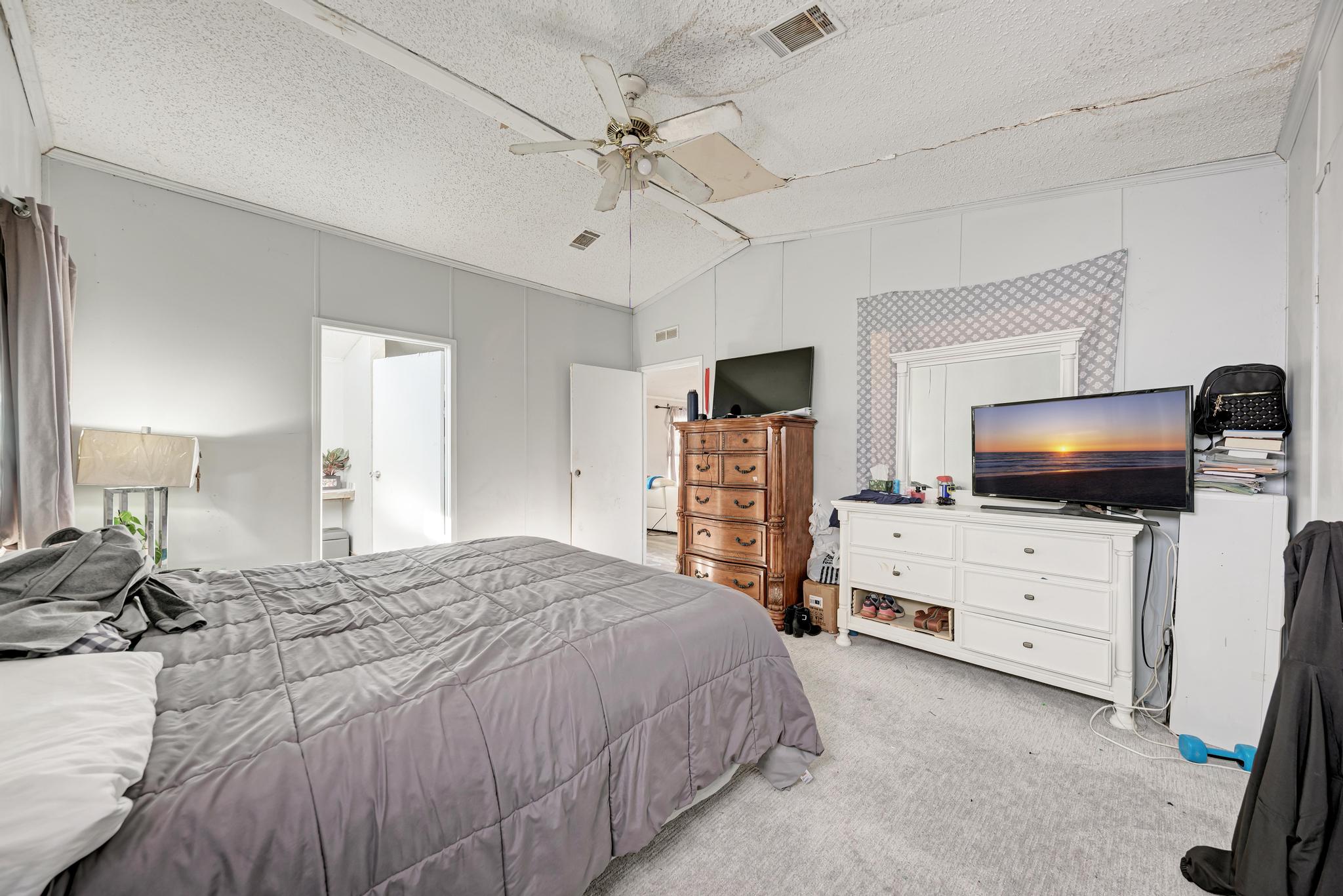 20113 Maynard Court Coupland, TX 78615 - Photo 16 of 37 a bedroom with furniture and flat screen tv