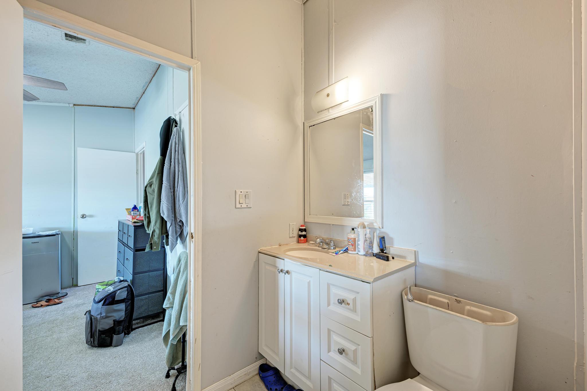20113 Maynard Court Coupland, TX 78615 - Photo 21 of 37 a view of bathroom with a sink and mirror