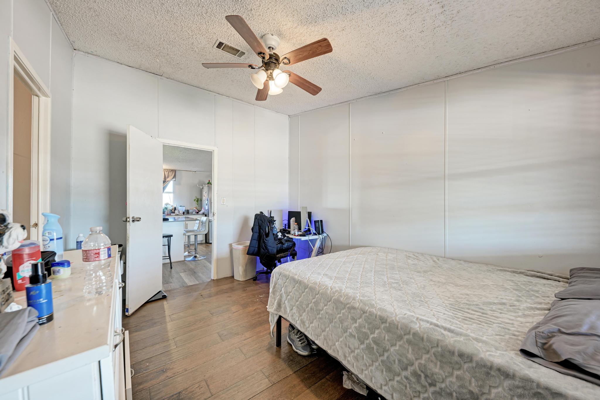 20113 Maynard Court Coupland, TX 78615 - Photo 23 of 37 a bedroom with a bed and a chandelier
