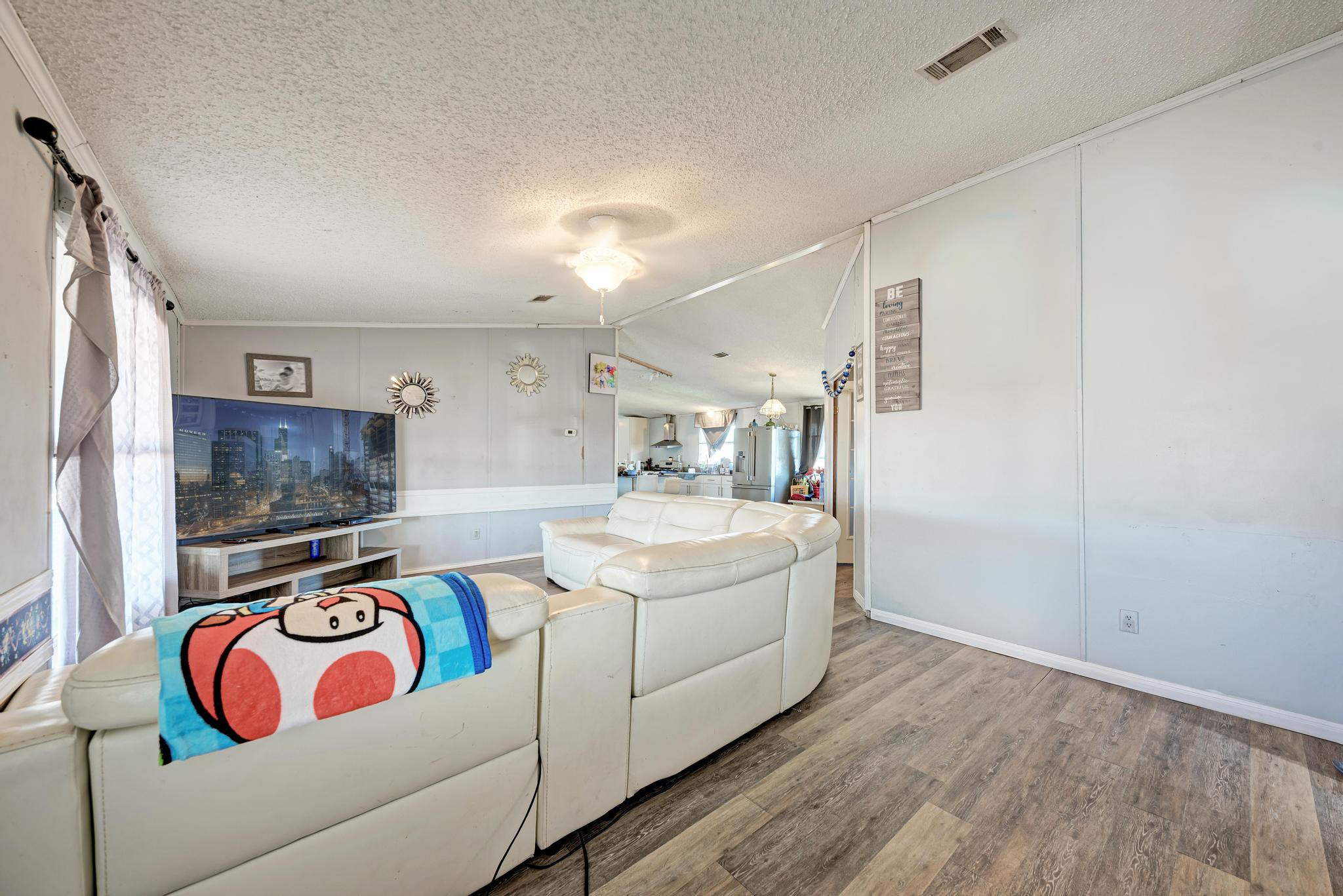 20113 Maynard Court Coupland, TX 78615 - Photo 7 of 37 a living room with furniture and a flat screen tv