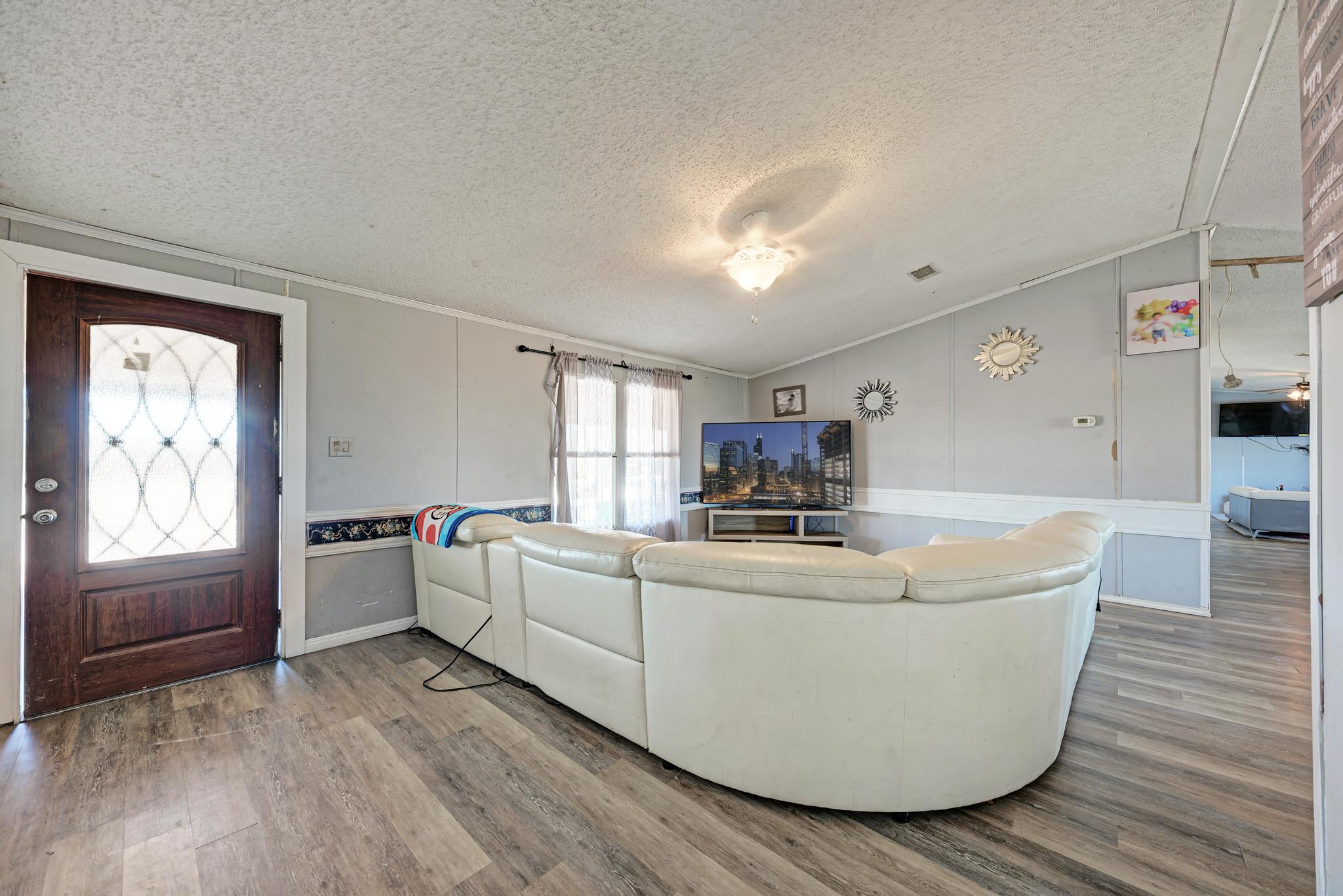 20113 Maynard Court Coupland, TX 78615 - Photo 8 of 37 a living room with stainless steel appliances furniture and a large window