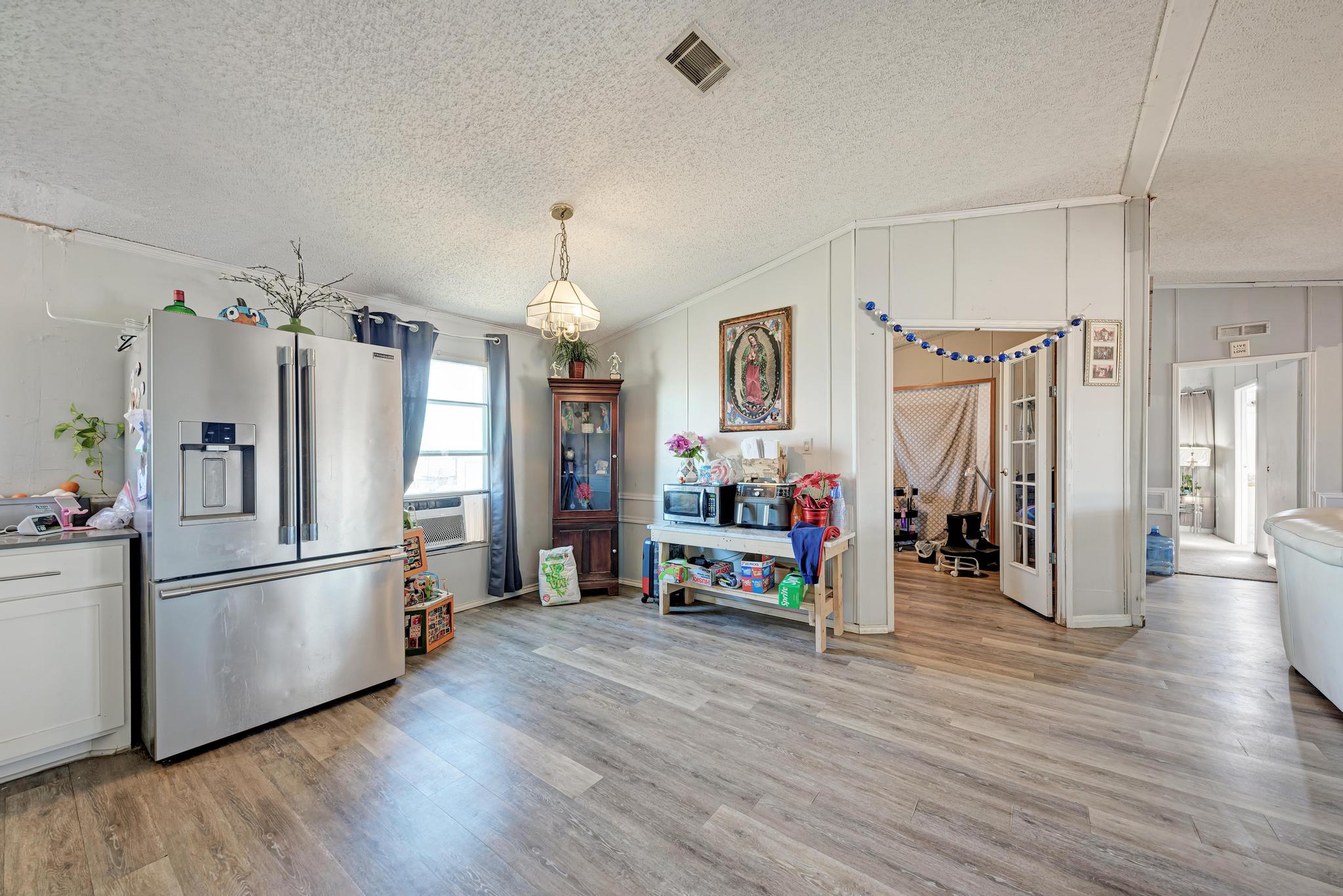 20113 Maynard Court Coupland, TX 78615 - Photo 10 of 37 a kitchen with stainless steel appliances a refrigerator and wooden floor