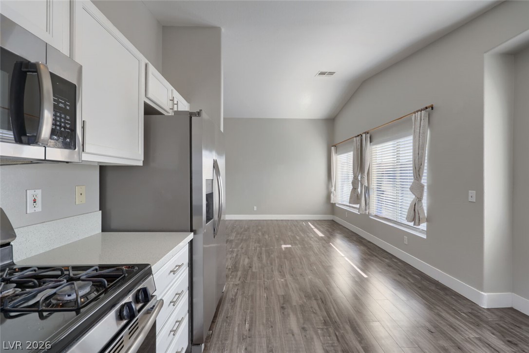 5985 High Steed Street, Unit 101 Henderson, NV 89011 - Photo 11 of 38 Clean lines and a spacious layout define this modern kitchen and living area.