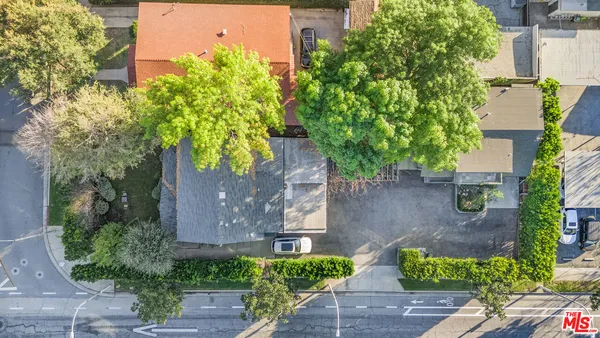 an aerial view of a house with garden space and street view