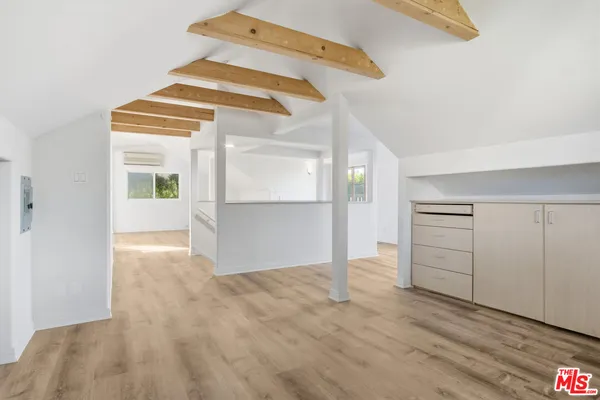a view of a hallway with wooden floor and entryway