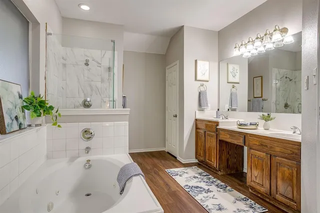 a bathroom with a tub sink and mirror