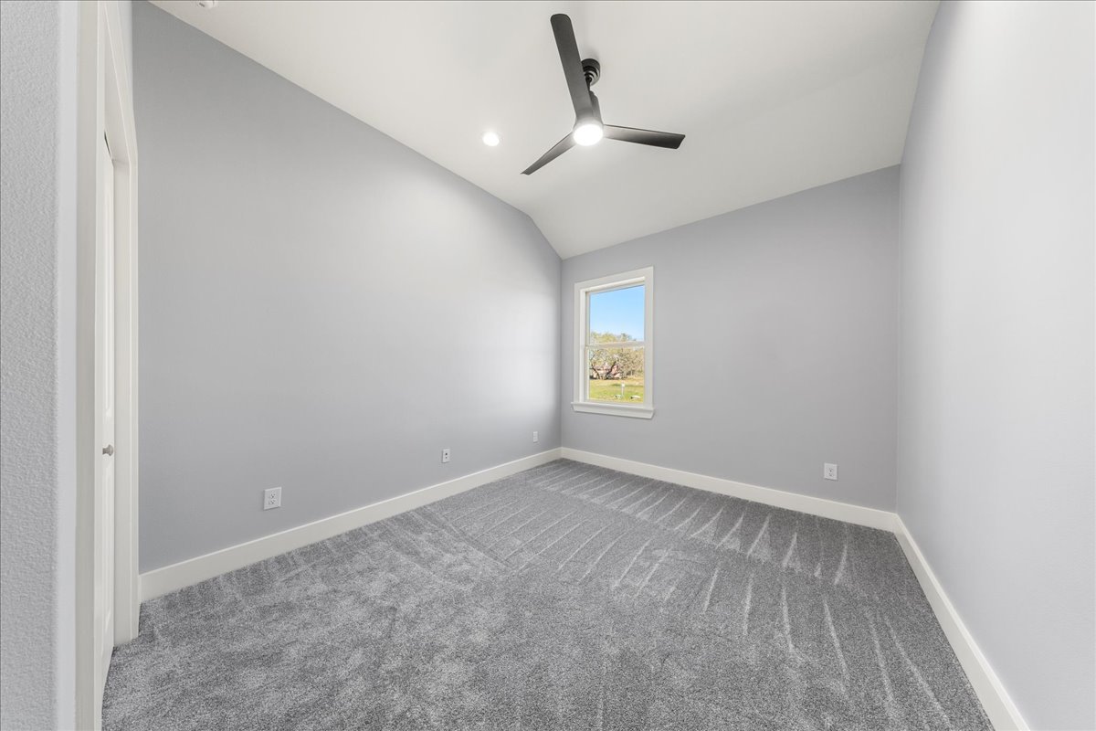 217 Gato Road Cedar Creek, TX 78612 - Photo 29 of 40 an empty room with a window and a ceiling fan