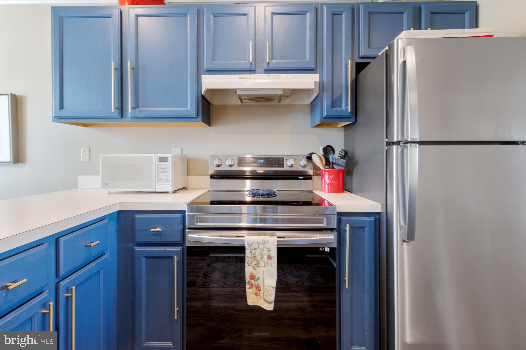 37896 Marina Road, Unit 4 Ocean View, DE 19970 - Photo 13 of 78 a kitchen with stainless steel appliances granite countertop a refrigerator and a stove top oven