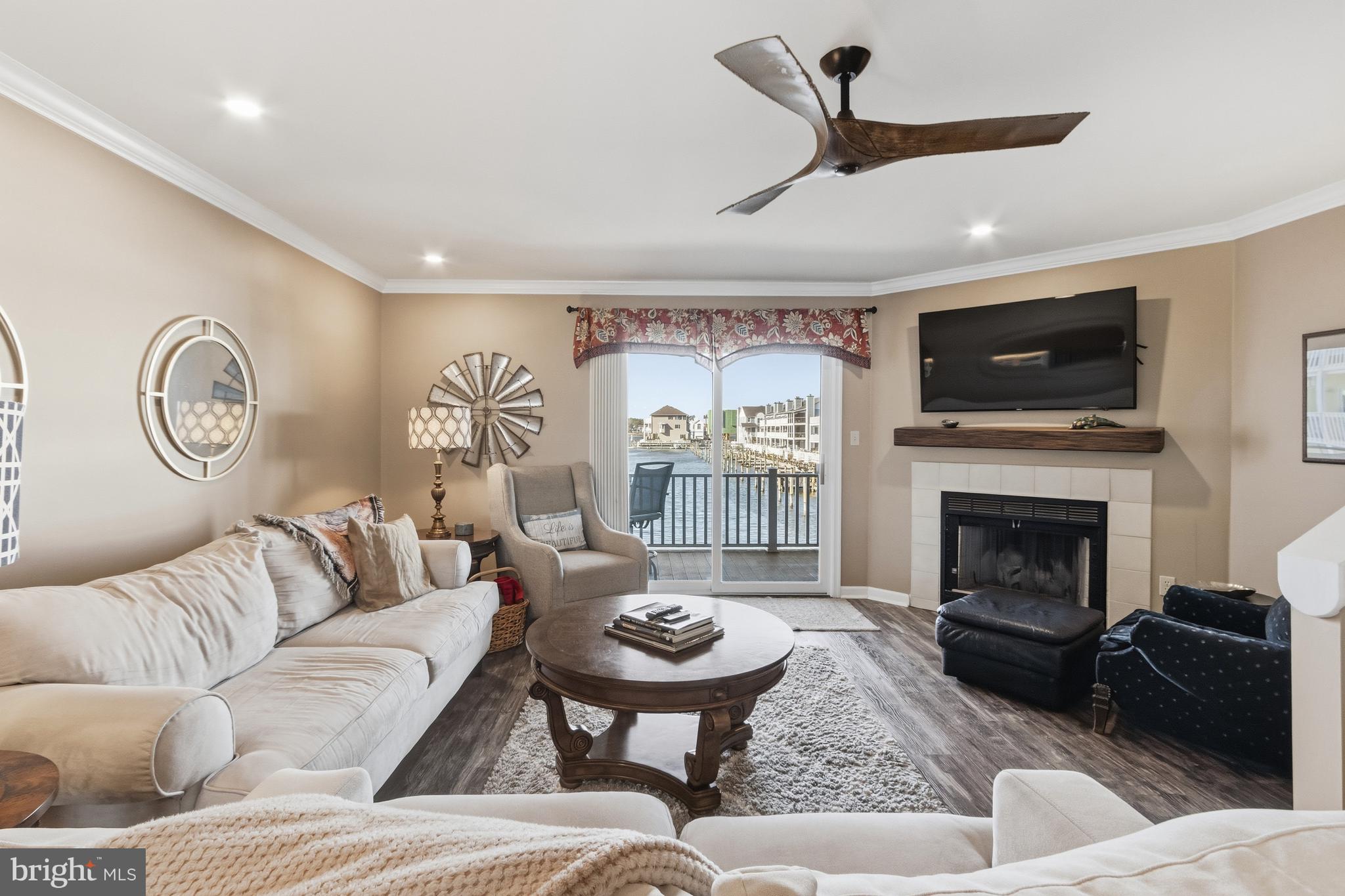37896 Marina Road, Unit 4 Ocean View, DE 19970 - Photo 19 of 78 a living room with furniture a flat screen tv and a fireplace