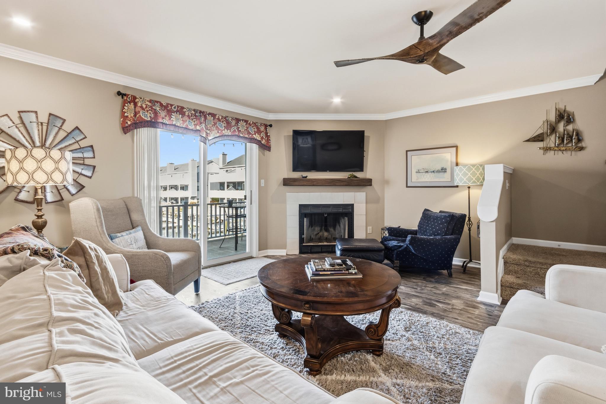37896 Marina Road, Unit 4 Ocean View, DE 19970 - Photo 20 of 78 a living room with furniture a fireplace and a flat screen tv